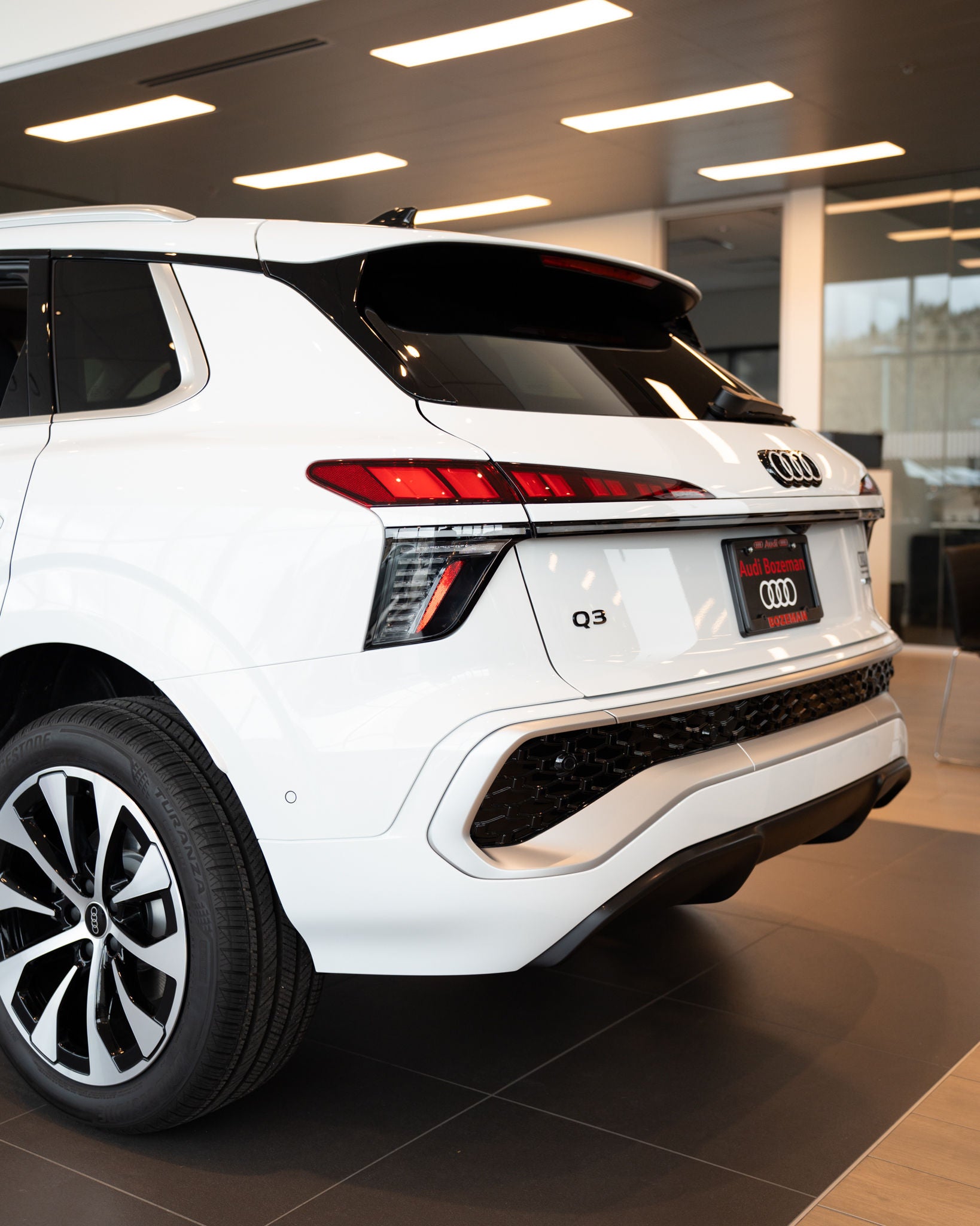 2026 Audi Q3 rear end view parked inside auto dealer Audi Bozeman